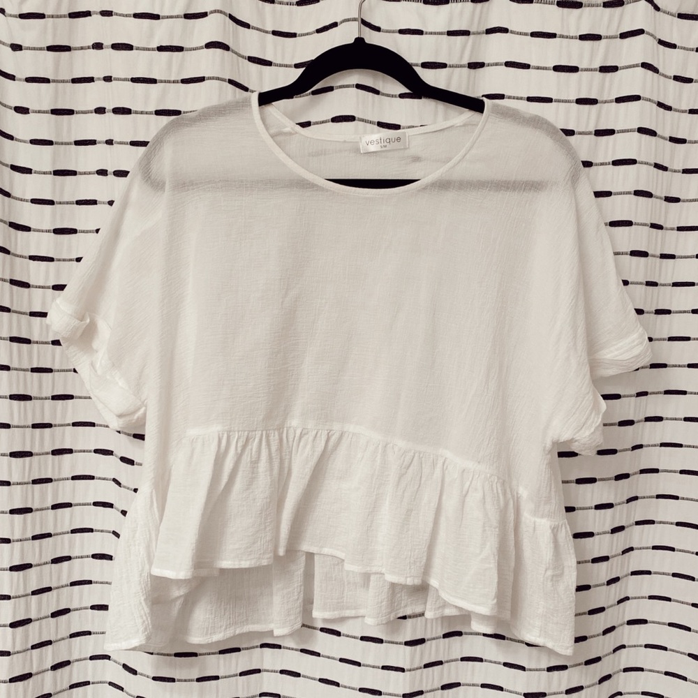White vestique blouse. Not quite cropped but short